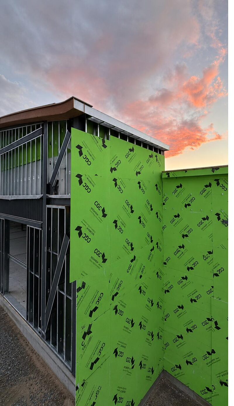 Exterior sheathing at a building corner at dusk