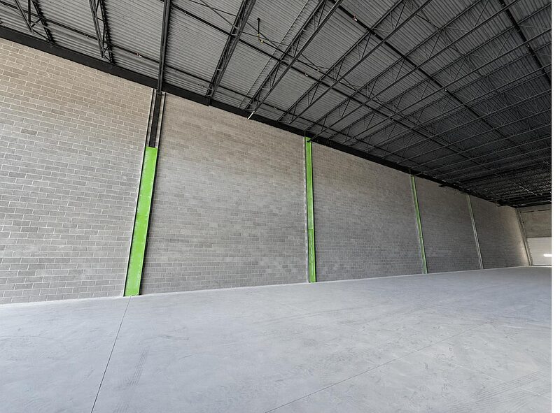 Commercial interior with framing along a masonry wall