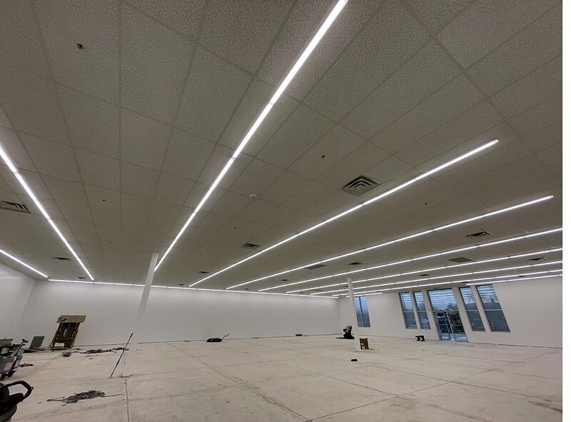 Commercial interior with installed acoustical ceiling and lighting